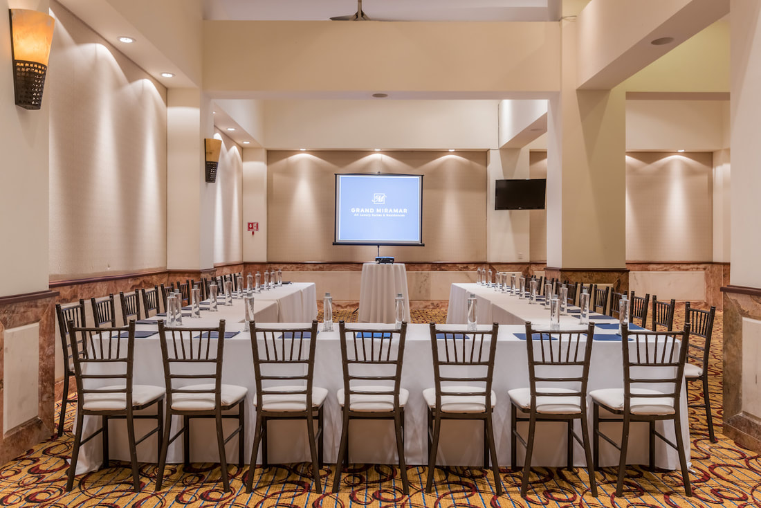 A conference room set up in an imperial or horesehoe style