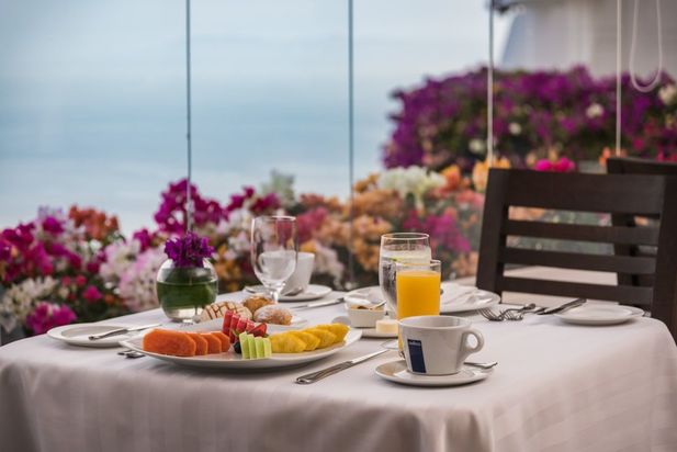 A simple breakfast with coffee and orange juice overlooking the ocean
